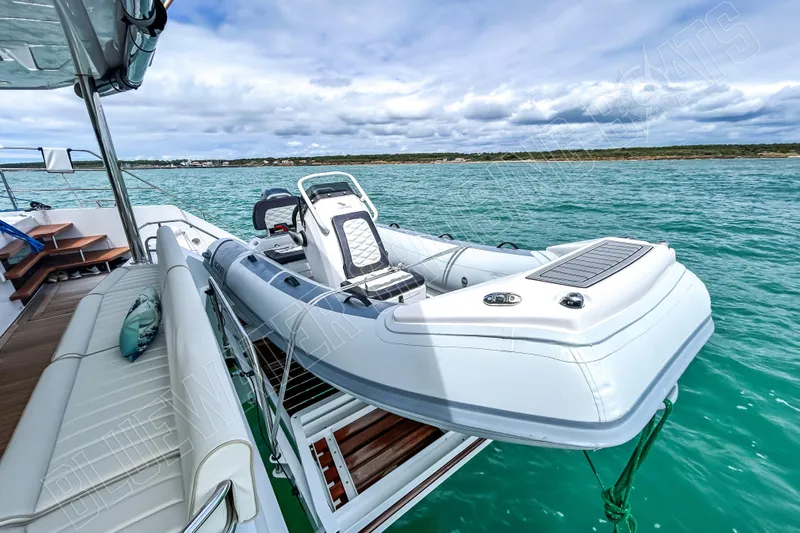 Fun Pass Yacht Photos Pics Luxury Privilege 580 yacht with tender, 2025 model, on turquoise water under cloudy sky.