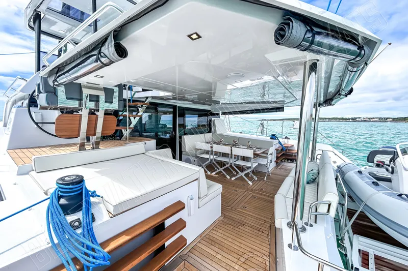 Fun Pass Yacht Photos Pics Luxurious 2025 Privilege 580 yacht deck with seating, dining area, and ocean view.