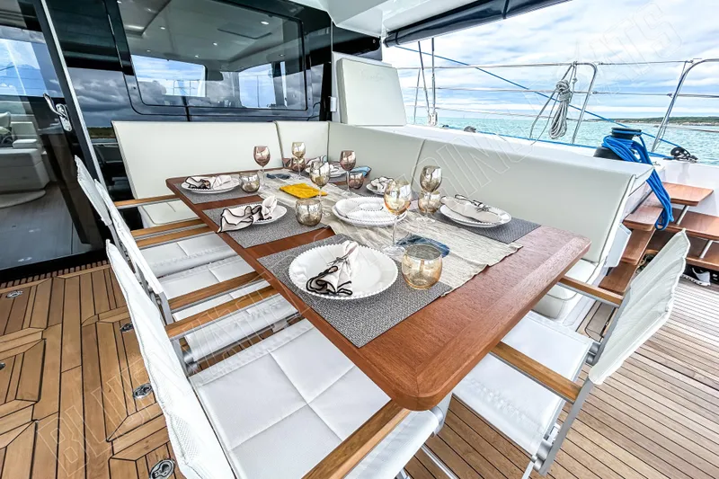 Fun Pass Yacht Photos Pics Luxurious dining setup on 2025 Privilege 580 yacht with elegant tableware and ocean view.