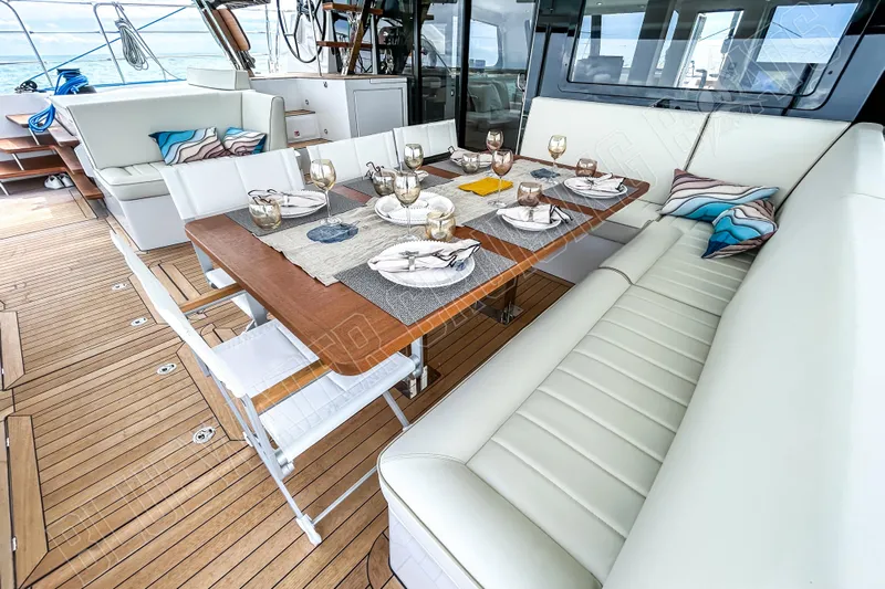 Fun Pass Yacht Photos Pics Luxurious dining area on 2025 Privilege 580 yacht with elegant table setting.