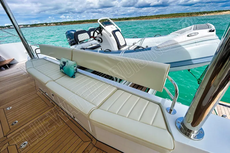 Fun Pass Yacht Photos Pics Luxurious Privilege 580 yacht deck with seating, overlooking turquoise waters, 2025 model.