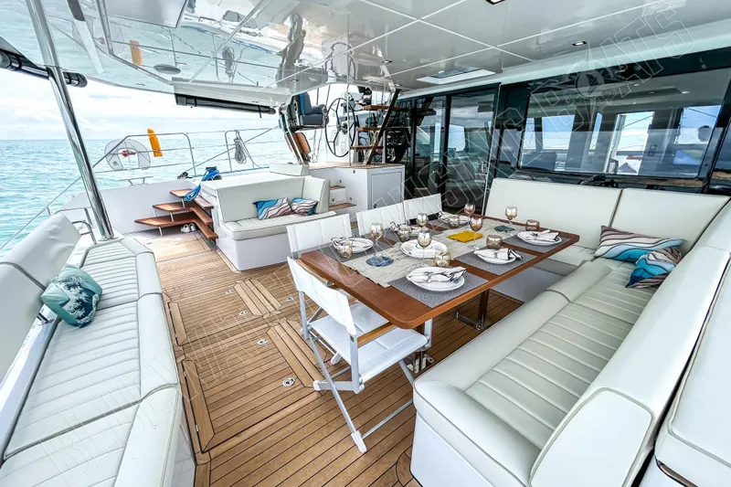 Fun Pass Yacht Photos Pics Luxurious 2025 Privilege 580 yacht interior with elegant dining setup and ocean view.