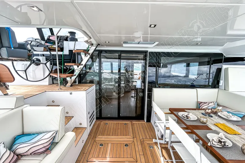 Fun Pass Yacht Photos Pics Luxurious interior of 2025 Privilege 580 yacht with elegant dining and steering area.