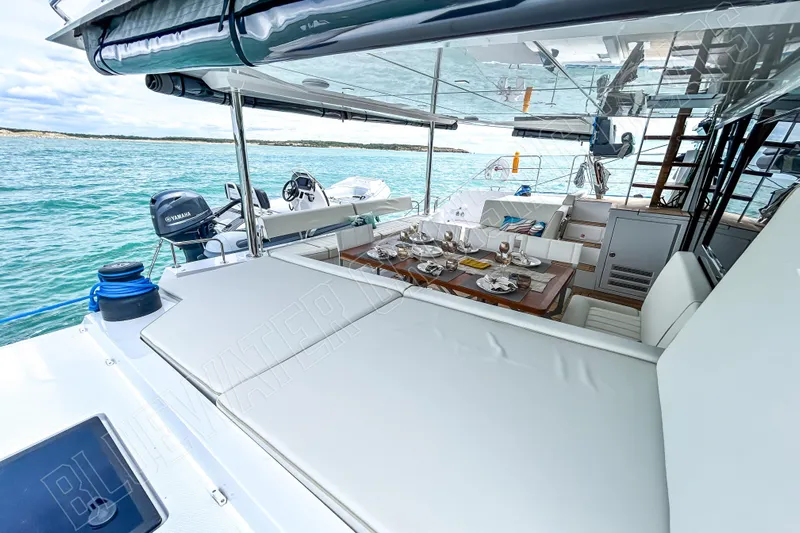 Fun Pass Yacht Photos Pics Luxurious 2025 Privilege 580 yacht with elegant outdoor dining area on serene waters.
