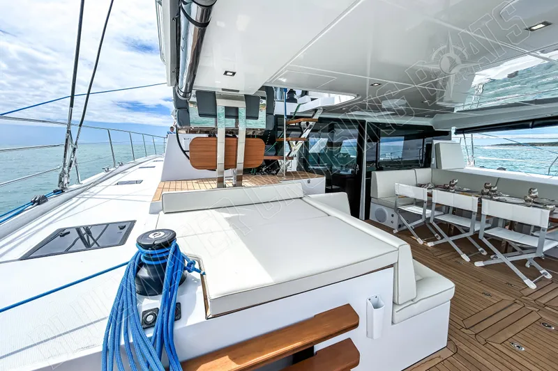 Fun Pass Yacht Photos Pics Luxurious 2025 Privilege 580 yacht deck with seating and dining area, ocean view.