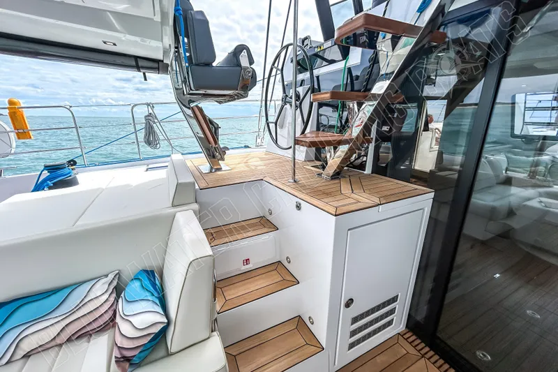 Fun Pass Yacht Photos Pics Luxury interior of 2025 Privilege 580 yacht with modern seating and wooden stairs.