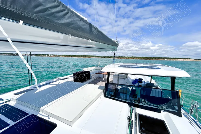 Fun Pass Yacht Photos Pics Luxury Privilege 580 yacht sailing on turquoise waters under a clear blue sky, 2025 model.