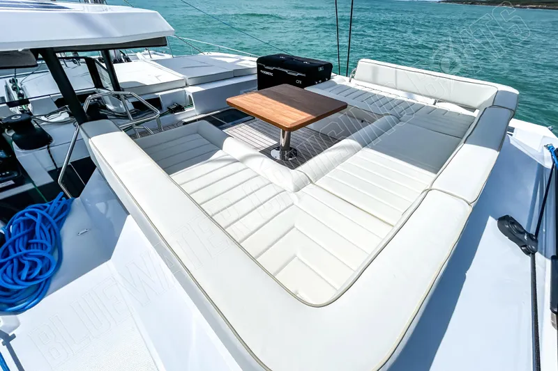Fun Pass Yacht Photos Pics Luxurious 2025 Privilege 580 yacht deck with white seating and wooden table.