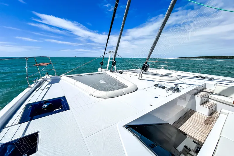 Fun Pass Yacht Photos Pics Luxury Privilege 580 yacht deck, 2025 model, sailing on turquoise ocean under clear blue sky.
