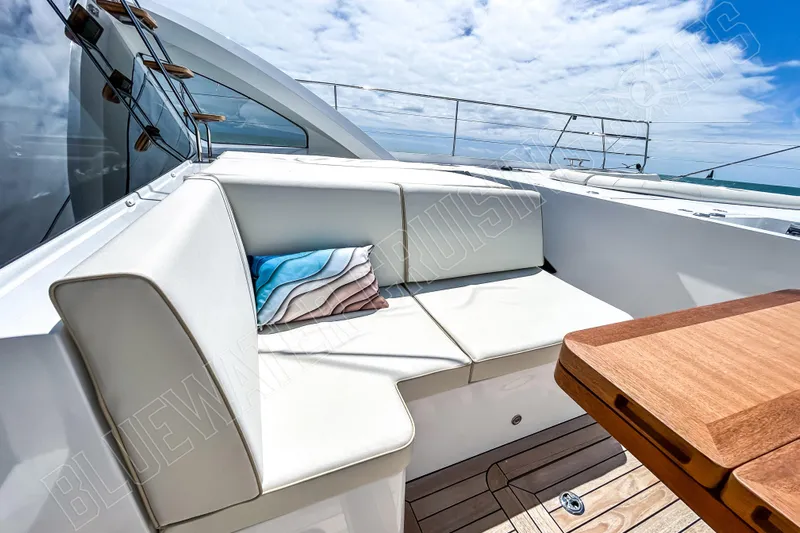 Fun Pass Yacht Photos Pics Luxurious Privilege 580 yacht deck with white seating and wooden table, 2025 model.