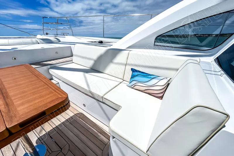 Fun Pass Yacht Photos Pics Luxury Privilege 580 yacht deck with white seating and wooden table, 2025 model.