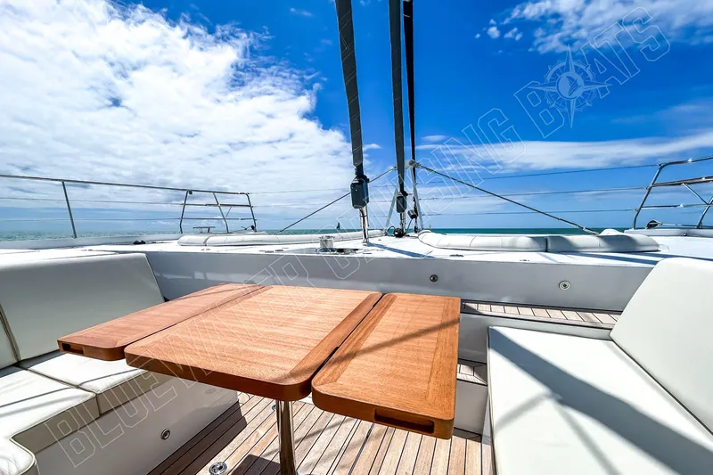 Fun Pass Yacht Photos Pics Luxury Privilege 580 yacht deck with wooden table, ocean view, and blue sky, 2025 model.