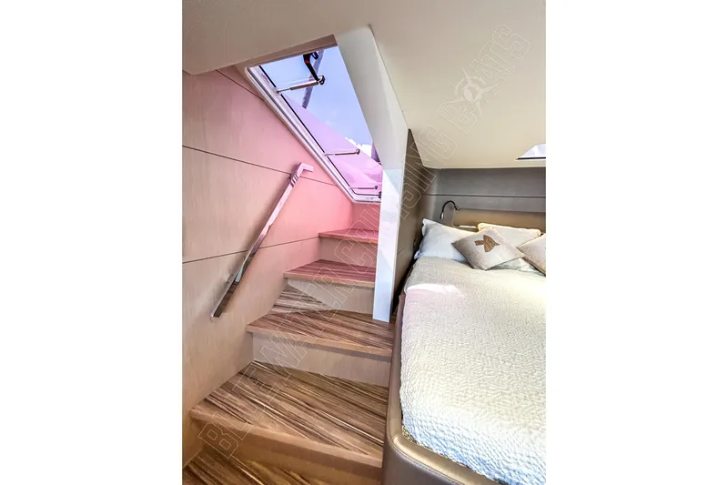 Fun Pass Yacht Photos Pics Luxurious interior of 2025 Privilege 580 yacht with elegant staircase and cozy bedroom.