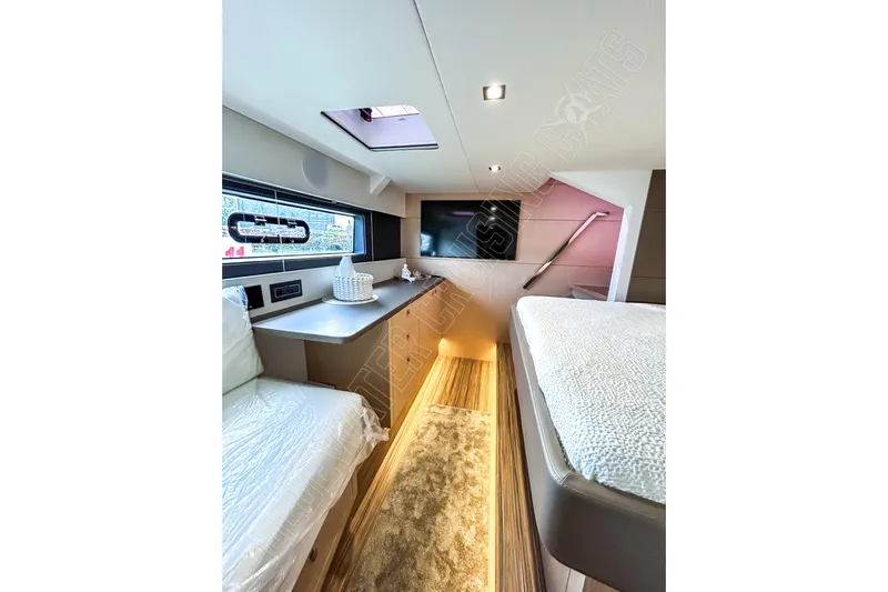 Fun Pass Yacht Photos Pics Luxurious interior of 2025 Privilege 580 yacht cabin with modern furnishings and natural light.