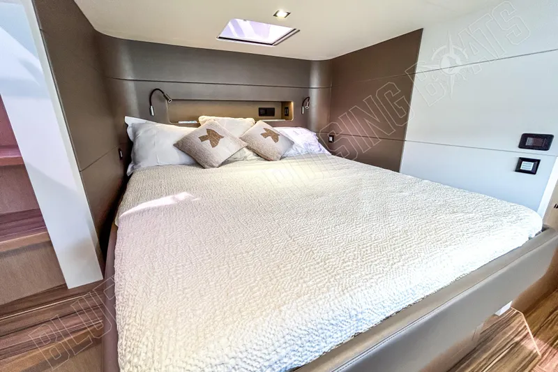 Fun Pass Yacht Photos Pics Luxurious cabin interior of 2025 Privilege 580 yacht with cozy bedding and modern design.