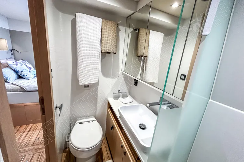 Fun Pass Yacht Photos Pics Modern bathroom in 2025 Privilege 580 yacht, featuring sleek design and elegant fixtures.