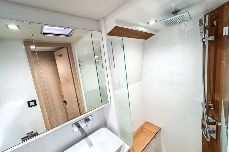 Fun Pass Yacht Photos Pics Modern bathroom interior on 2025 Privilege 580 yacht, featuring sleek design and wooden accents.