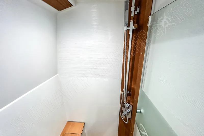Fun Pass Yacht Photos Pics Modern shower area in 2025 Privilege 580 yacht, featuring sleek design and wooden accents.