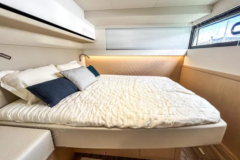 Fun Pass Yacht Photos Pics Luxurious bedroom interior of 2025 Privilege 580 yacht with cozy bedding and modern design.