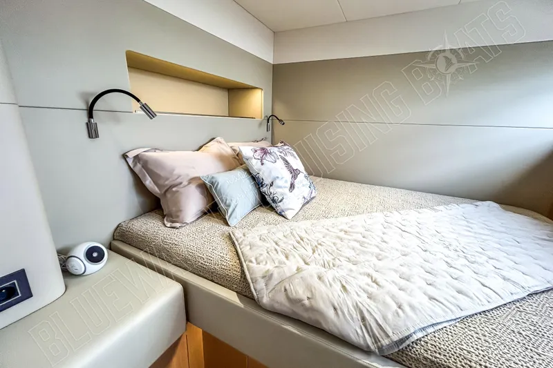Fun Pass Yacht Photos Pics Luxurious cabin interior of 2025 Privilege 580 yacht with cozy bedding and modern lighting.
