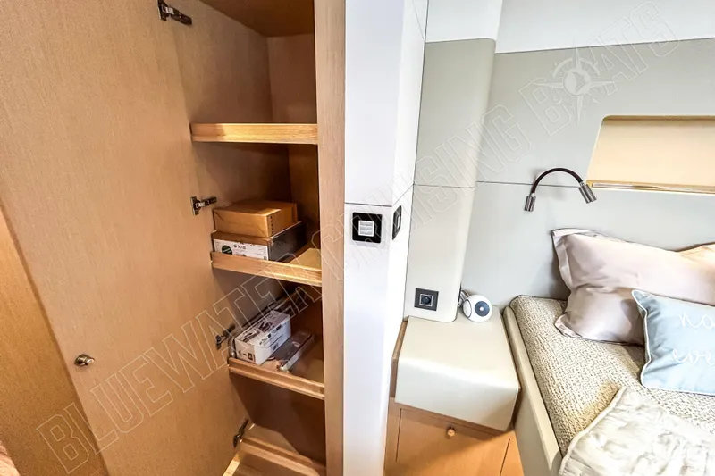 Fun Pass Yacht Photos Pics Modern Privilege 580 yacht interior with wooden shelves and cozy bedroom, 2025 model.