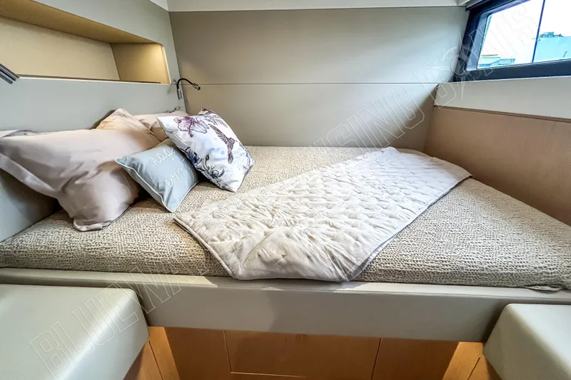 Fun Pass Yacht Photos Pics Luxurious cabin interior of 2025 Privilege 580 yacht with cozy bedding and pillows.