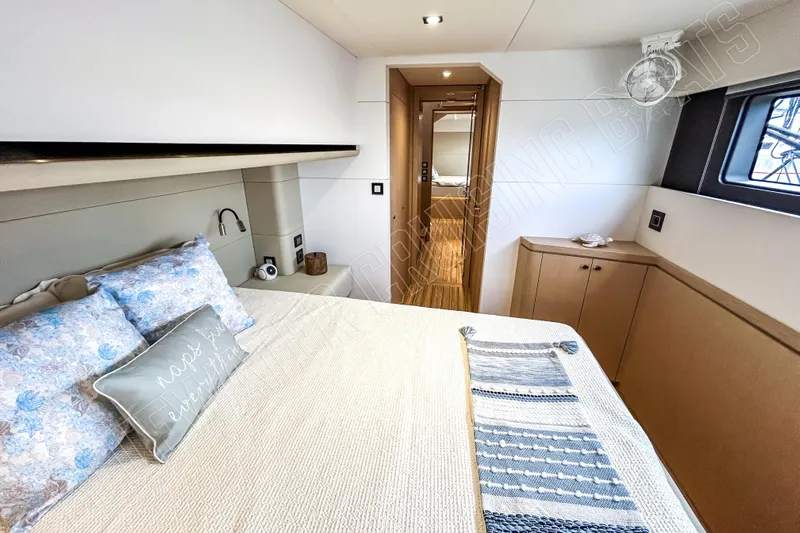 Fun Pass Yacht Photos Pics Luxurious cabin interior of 2025 Privilege 580 yacht, featuring elegant bedding and modern design.