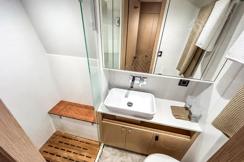Fun Pass Yacht Photos Pics Modern bathroom in 2025 Privilege 580 yacht with sleek design and wooden accents.