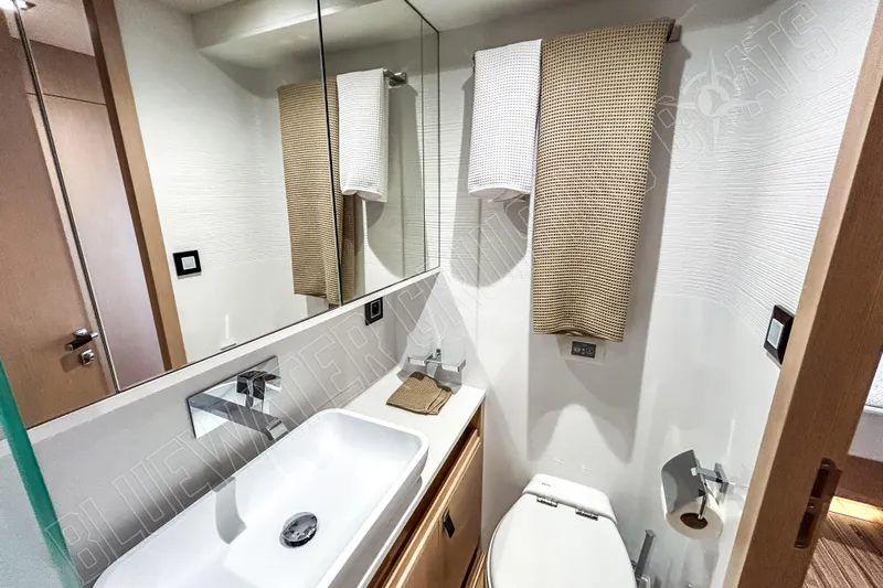 Fun Pass Yacht Photos Pics Modern bathroom in 2025 Privilege 580 yacht with sleek fixtures and elegant design.