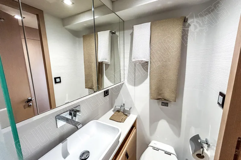 Fun Pass Yacht Photos Pics Modern bathroom in 2025 Privilege 580 yacht with sleek fixtures and elegant design.