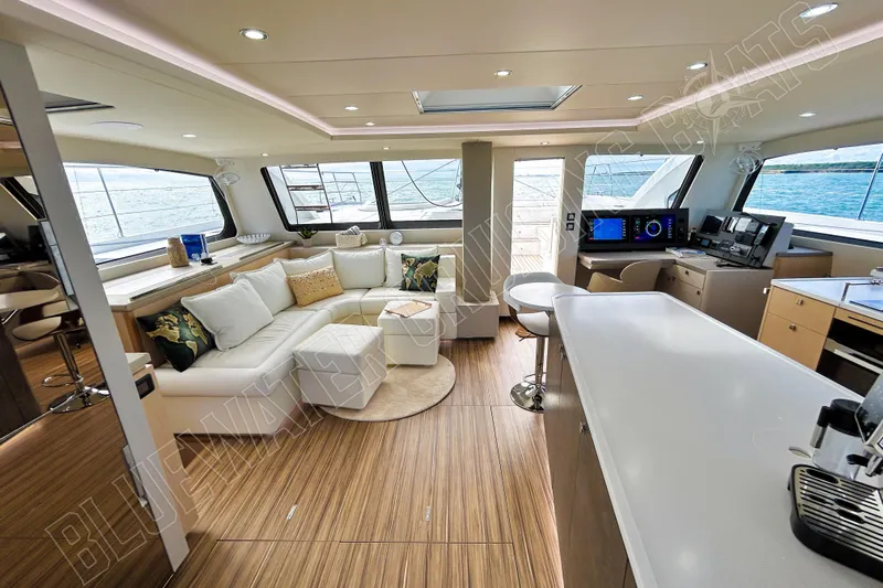 Fun Pass Yacht Photos Pics Luxurious interior of 2025 Privilege 580 yacht with modern furnishings and panoramic windows.
