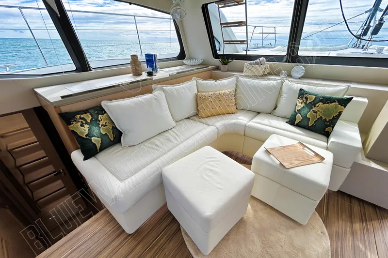 Fun Pass Yacht Photos Pics Luxurious interior of 2025 Privilege 580 yacht with elegant white seating and ocean view.