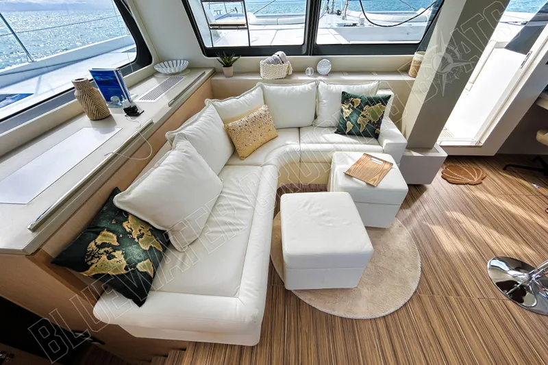 Fun Pass Yacht Photos Pics Luxurious interior of 2025 Privilege 580 yacht with elegant white seating and ocean view.