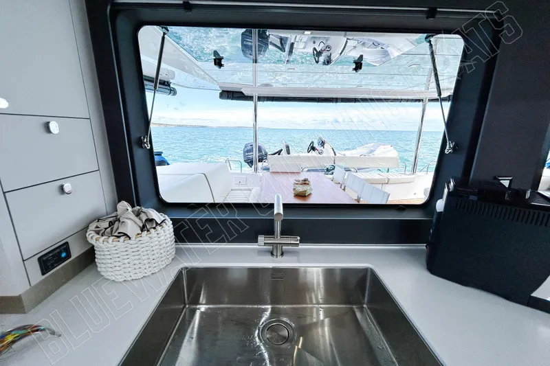 Fun Pass Yacht Photos Pics Modern kitchen view on Privilege 580 yacht, overlooking ocean and deck seating, 2025 model.