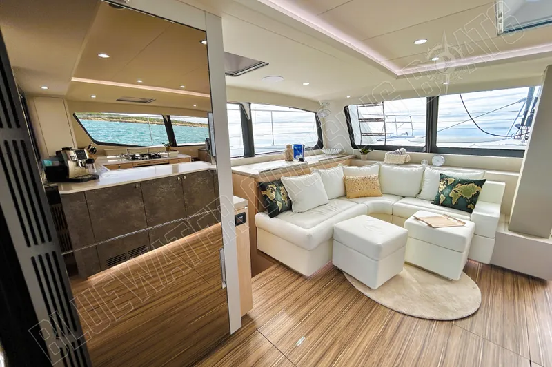 Fun Pass Yacht Photos Pics Luxurious interior of 2025 Privilege 580 yacht with modern kitchen and cozy seating area.