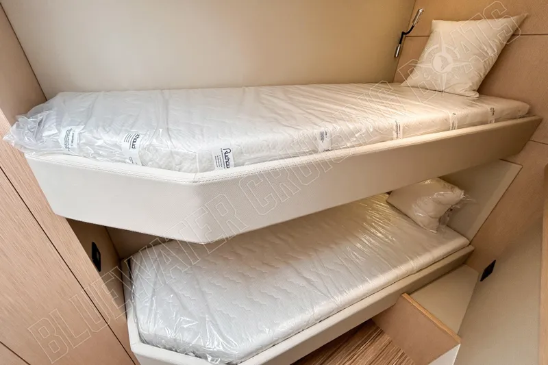 Fun Pass Yacht Photos Pics Bunk beds in 2025 Privilege 580 yacht cabin, featuring modern design and comfortable mattresses.