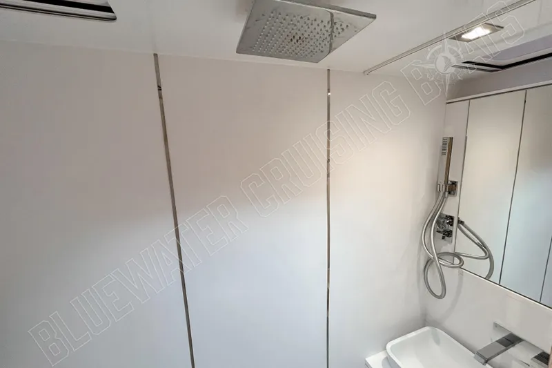 Fun Pass Yacht Photos Pics Modern bathroom in 2025 Privilege 580 yacht with sleek shower and fixtures.