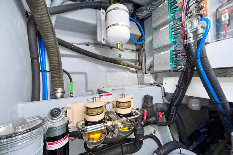 Fun Pass Yacht Photos Pics Engine room of 2025 Privilege 580 yacht, showcasing complex wiring and filtration systems.
