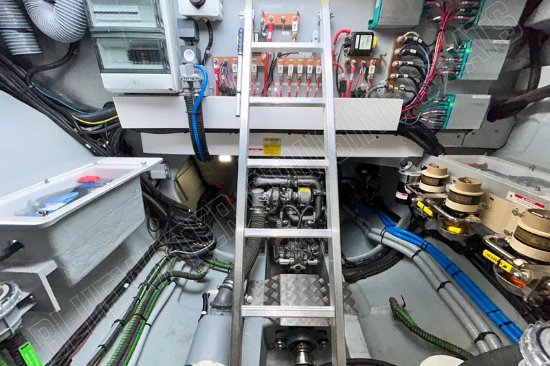 Fun Pass Yacht Photos Pics Engine room of 2025 Privilege 580 yacht, featuring complex wiring and machinery.