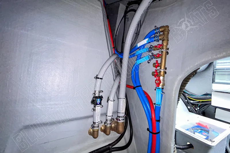 Fun Pass Yacht Photos Pics Plumbing system inside 2025 Privilege 580 yacht, featuring pipes and valves.