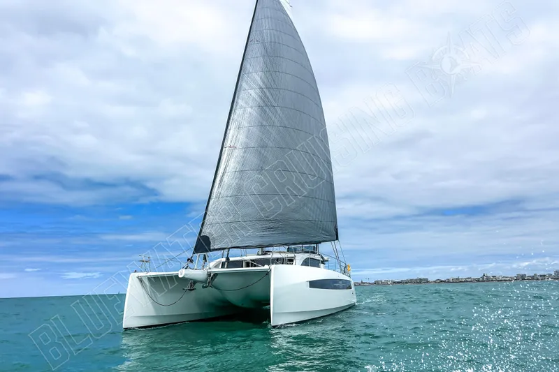 Fun Pass Yacht Photos Pics Sailing catamaran Privilege 580, 2025 model, cruising on open water under cloudy skies.