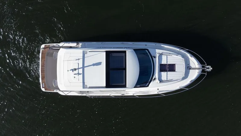  Yacht Photos Pics Aerial view of 2021 Jeanneau NC 37 yacht on dark water.