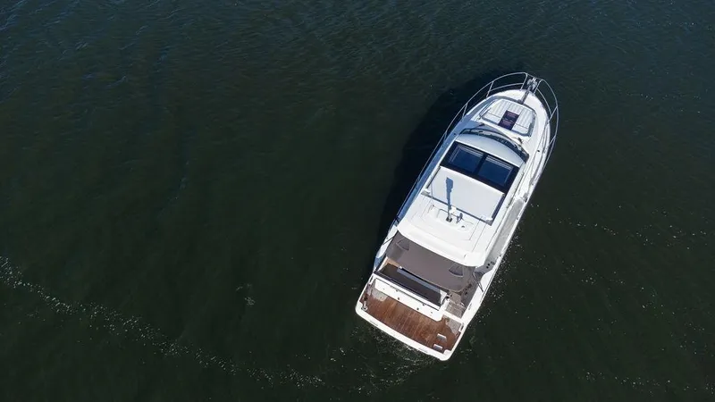  Yacht Photos Pics Aerial view of 2021 Jeanneau NC 37 boat cruising on open water.
