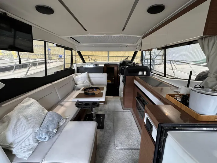  Yacht Photos Pics Interior of 2021 Jeanneau NC 37 yacht with modern kitchen and seating area.