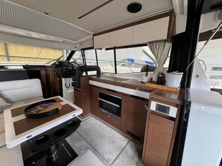  Yacht Photos Pics Interior of 2021 Jeanneau NC 37 boat with modern kitchen and seating area.