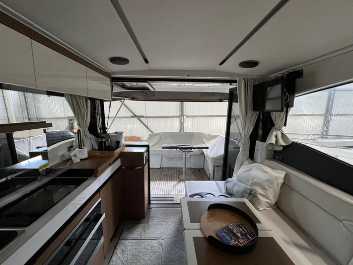  Yacht Photos Pics Interior of 2021 Jeanneau NC 37 yacht, featuring modern kitchen and seating area.