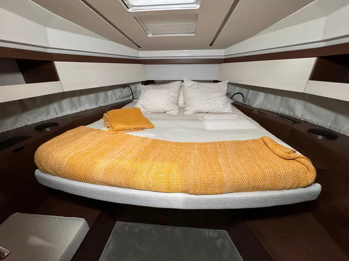  Yacht Photos Pics Cozy cabin interior of 2021 Jeanneau NC 37 with a neatly made bed.