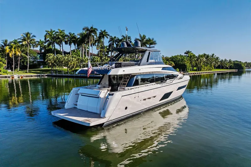 Sunsation Yacht Photos Pics 2019 Ferretti Yachts 780 cruising on a serene, palm-lined waterway.
