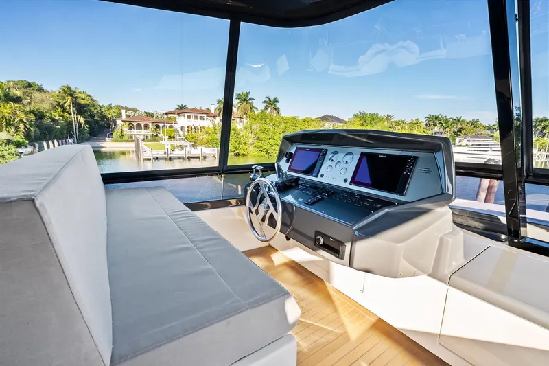 Sunsation Yacht Photos Pics Helm of 2019 Ferretti Yachts 780 with modern controls and scenic waterfront view.