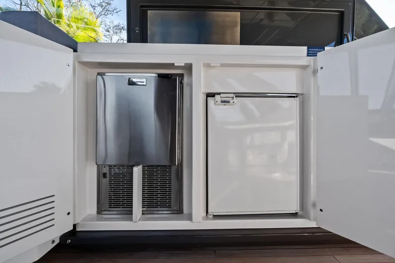 Sunsation Yacht Photos Pics Built-in fridge and ice maker on 2019 Ferretti Yachts 780, open cabinet view.